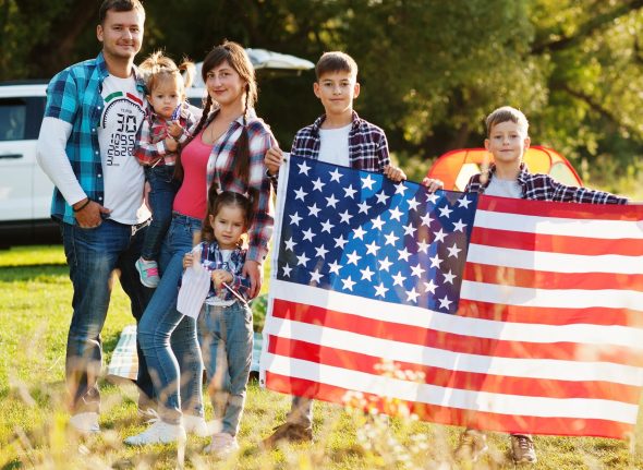 Large american family spending time together. With USA flag. America holiday. Four kids.